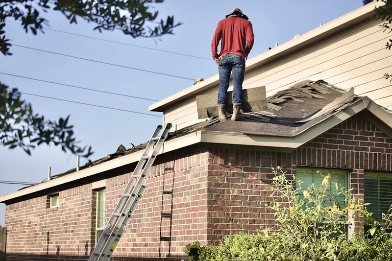 Professional roofer working on a residential roof in Downtown Chapel Hill